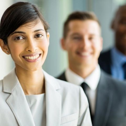 Woman leader standing in front of two men