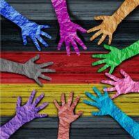 Rainbow colored hands making circle